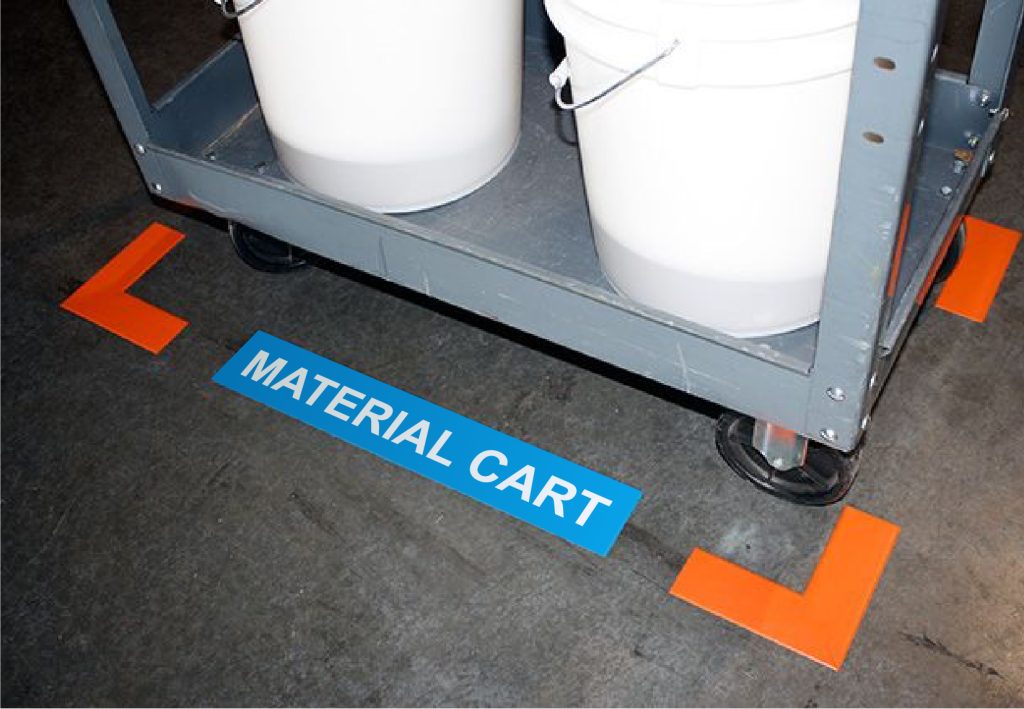 A photo of a material cart located between two orange Superior Mark® corner markers with a blue Superior Mark® floor label that says "Material Cart."